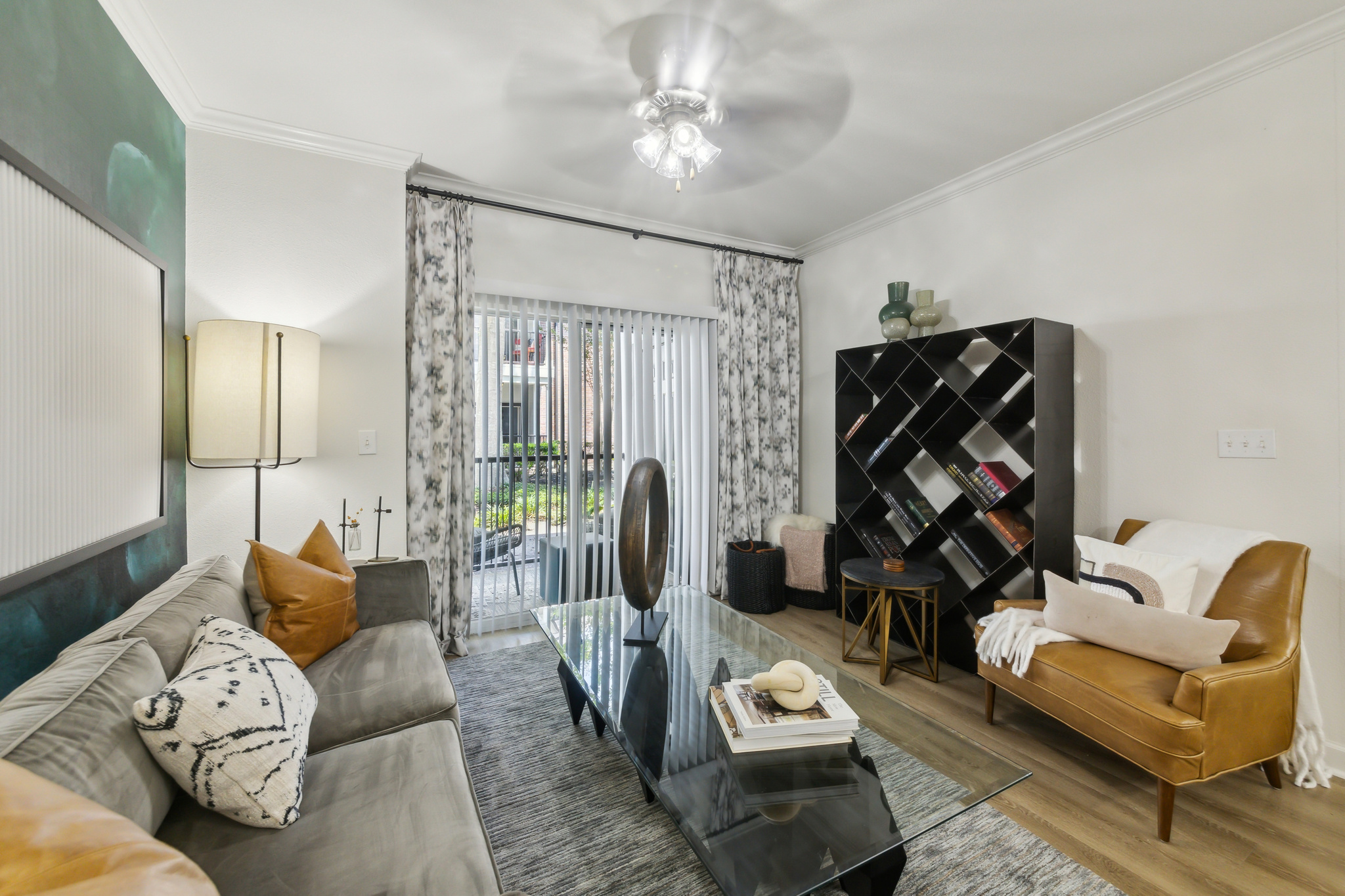 a living room with a couch, coffee table and television at The  Boulevard at Deer Park