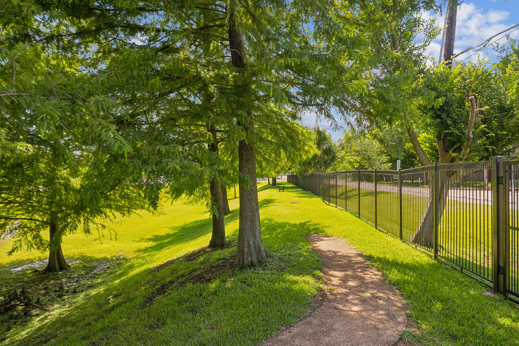 a path leads to a fenced in park area at The  Boulevard at Deer Park