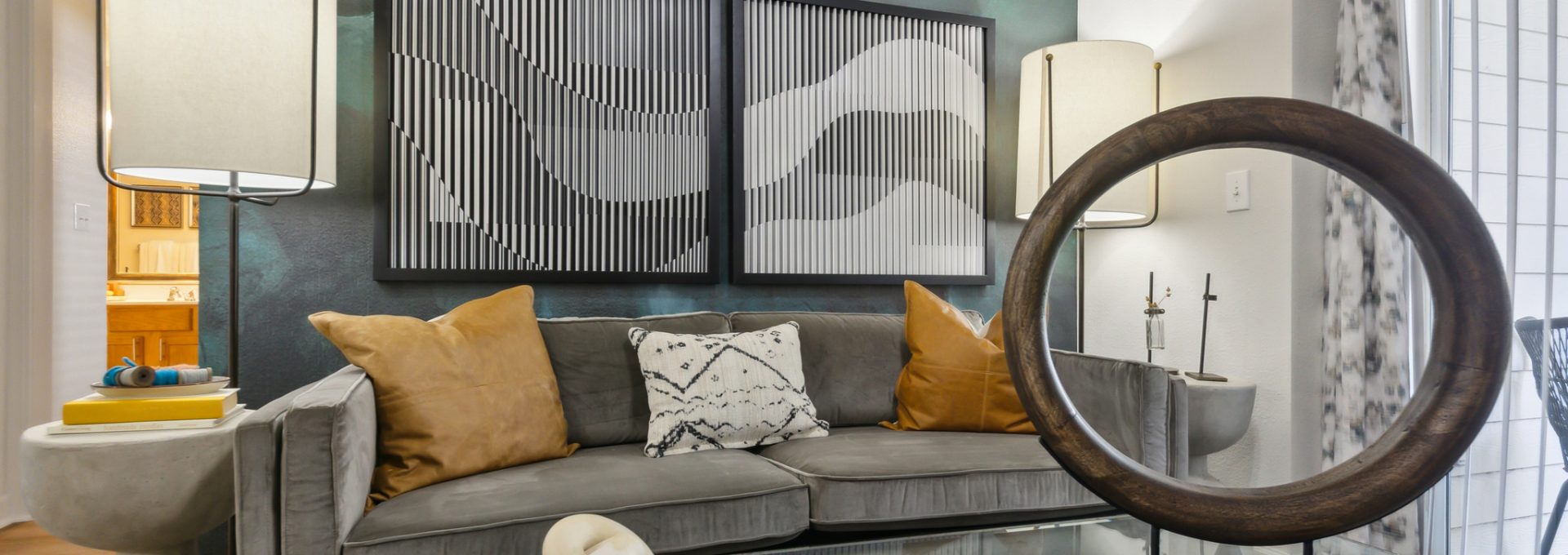 a living room with a large mirror and a coffee table at The  Boulevard at Deer Park