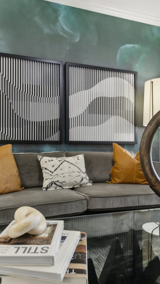 a living room with a large mirror and a coffee table at The  Boulevard at Deer Park