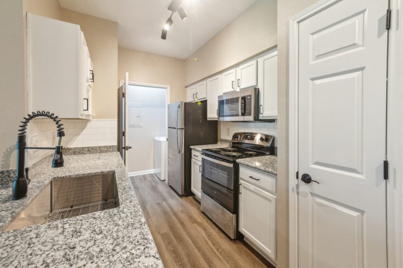 kitchen with granite counter tops and stainless steel appliances at The Boulevard at Deer Park