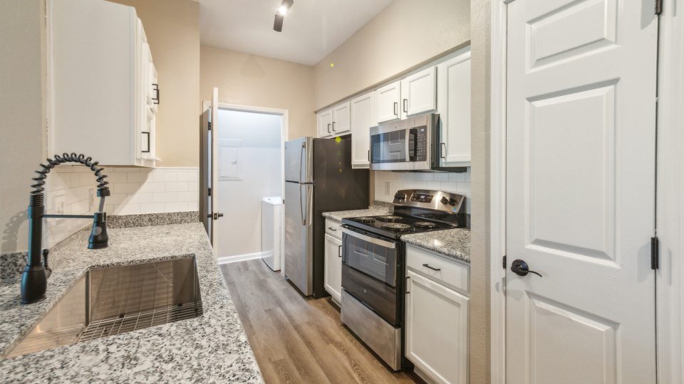kitchen with granite counter tops and stainless steel appliances at The Boulevard at Deer Park